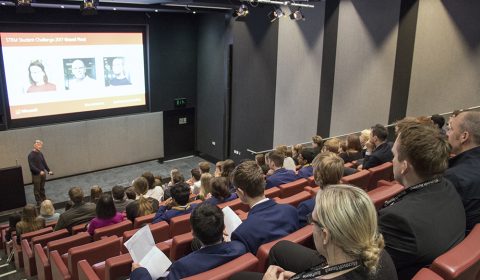 a group of people sitting in front of a crowd