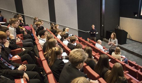 a group of people sitting in front of a crowd