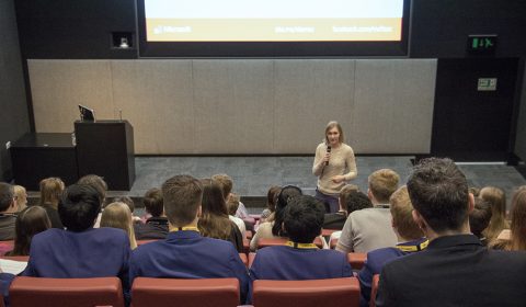 a group of people sitting in front of a television