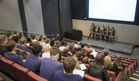 a group of people sitting in front of a crowd