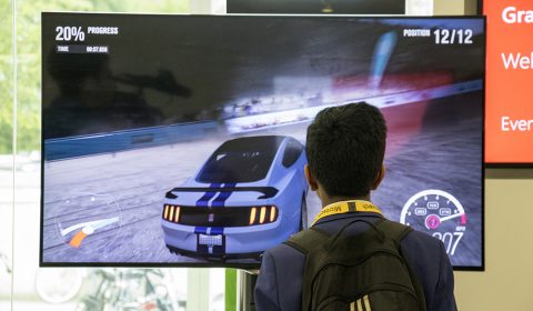 a man standing in front of a television