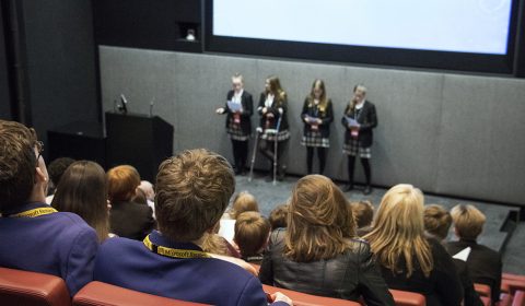 a group of people sitting in front of a television