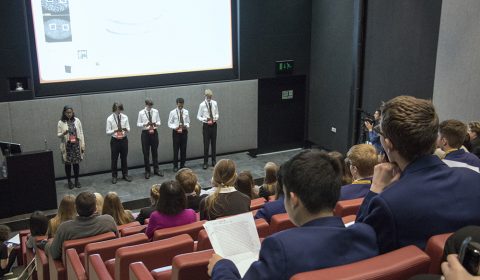 a group of people sitting in front of a television