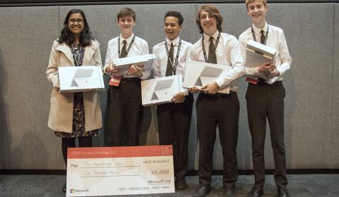 Zack Kopplin et al. standing in front of a box