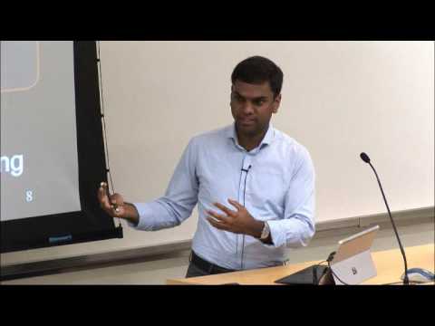a man standing in front of a computer screen