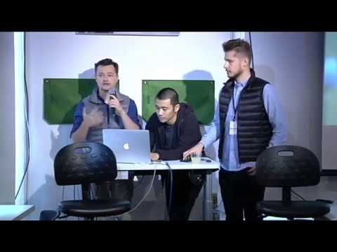 a group of people standing in front of a computer screen