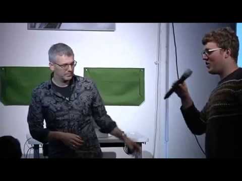 a man standing in front of a screen