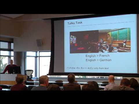a group of people sitting at a desk in front of a window