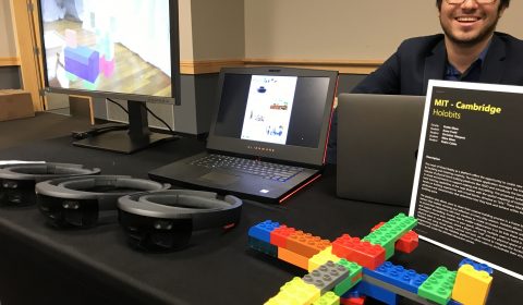 a man sitting at a desk in front of a laptop computer