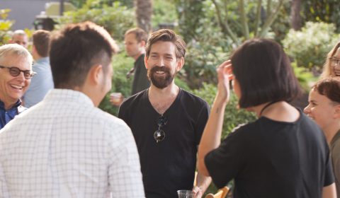 a group of people standing around each other