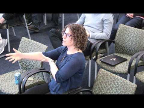a man sitting at a table using a laptop