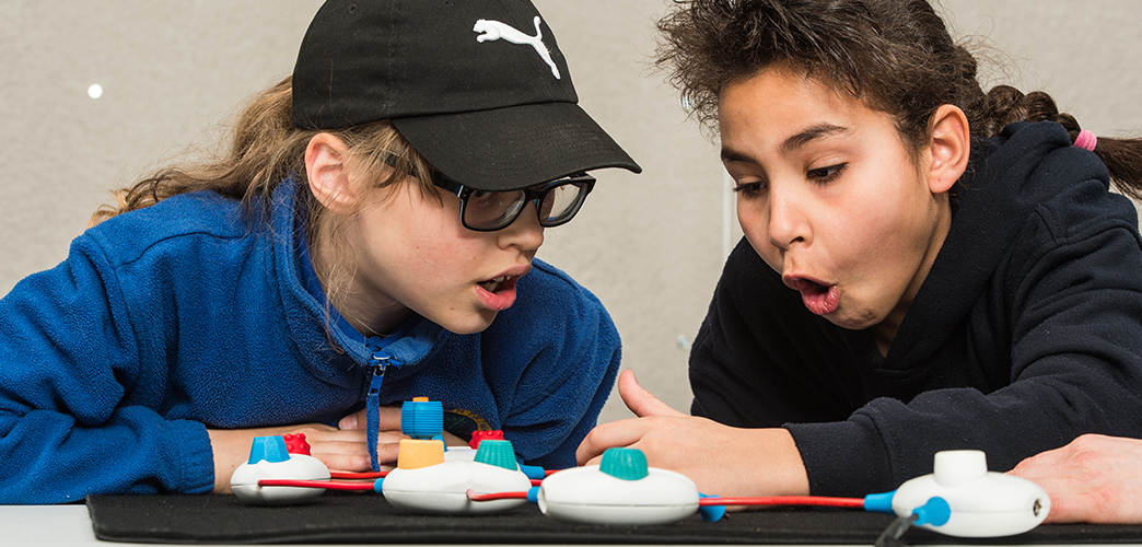 two girls using the physical coding objects from Project Torino