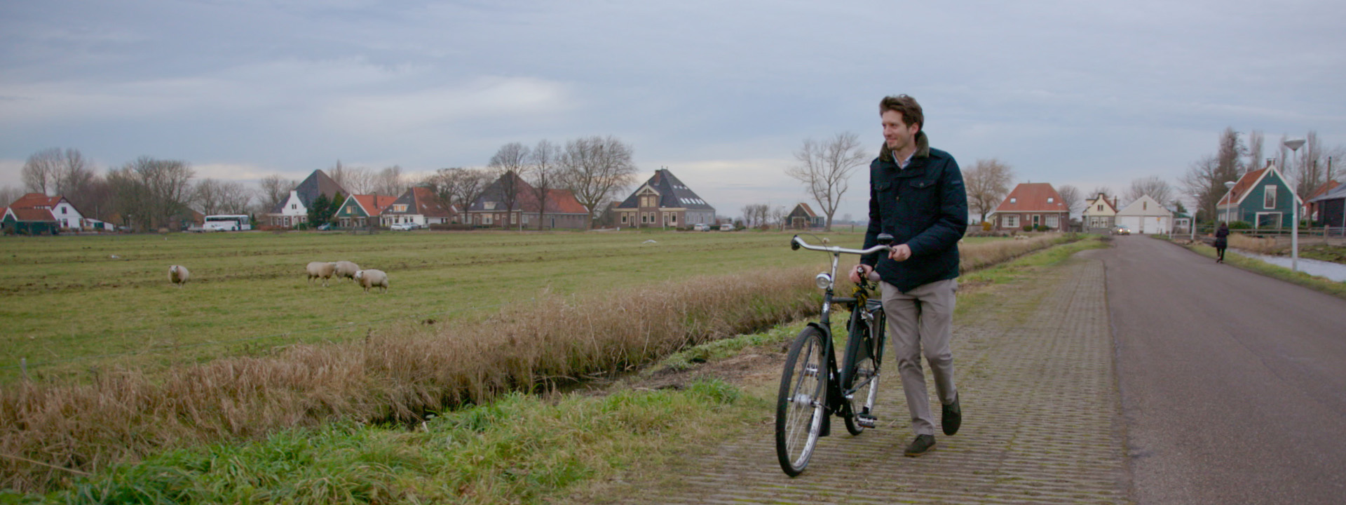 a man riding a bike down a dirt road