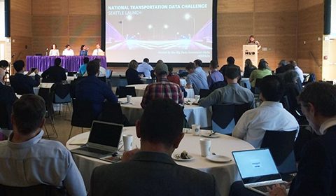 a group of people sitting at a table in front of a crowd