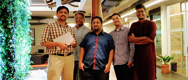 a person standing in front of a group of people posing for the camera