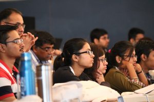 a group of people sitting in front of a crowd