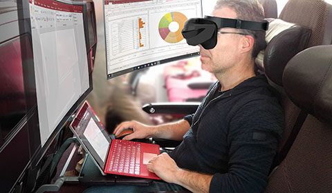 a man sitting in front of a laptop computer