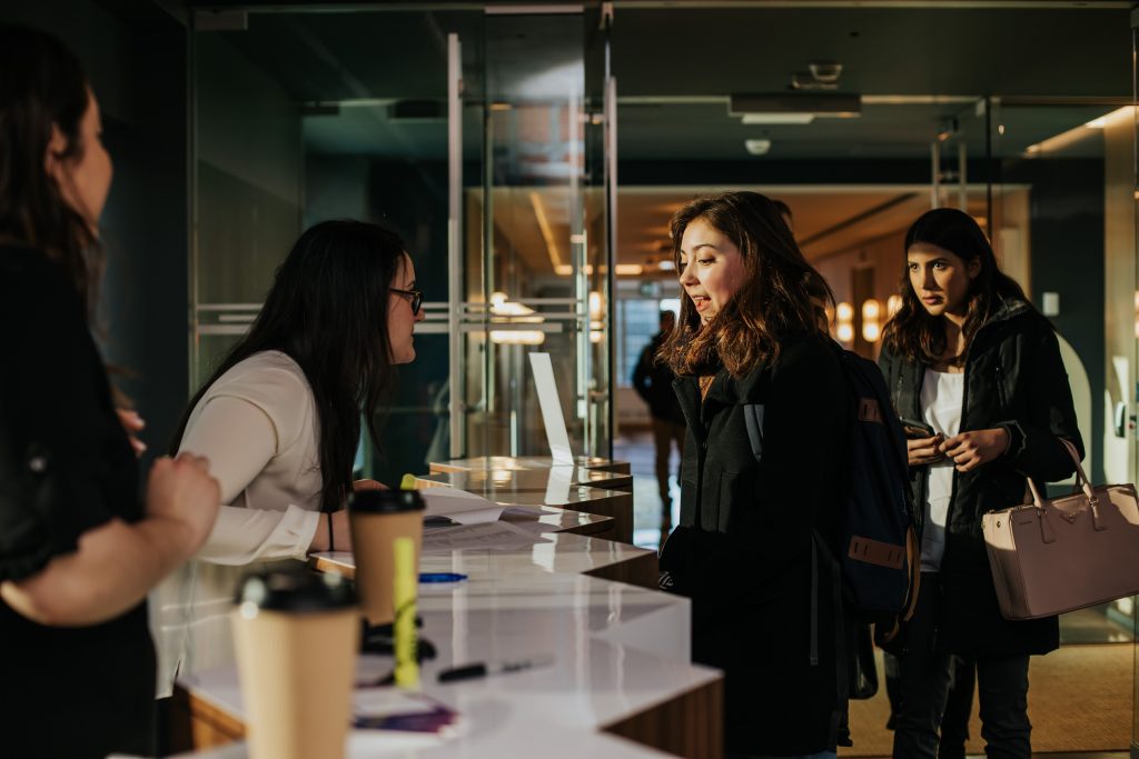 a group of people standing around a table