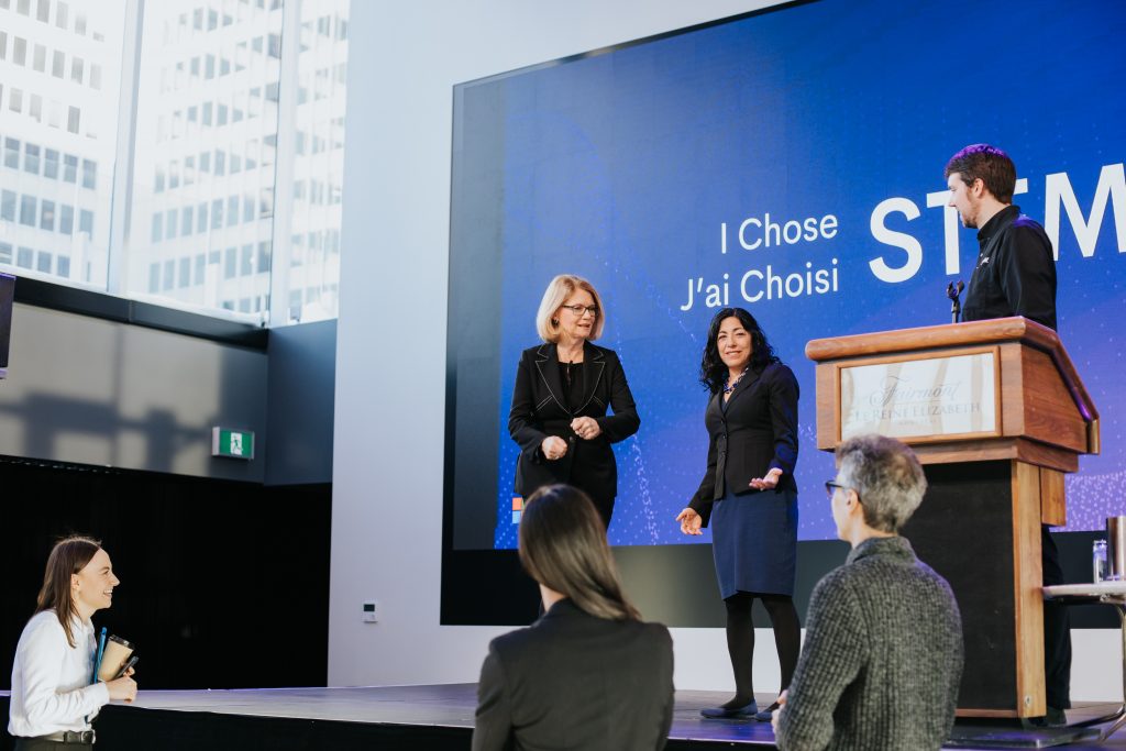a group of people standing in front of a television
