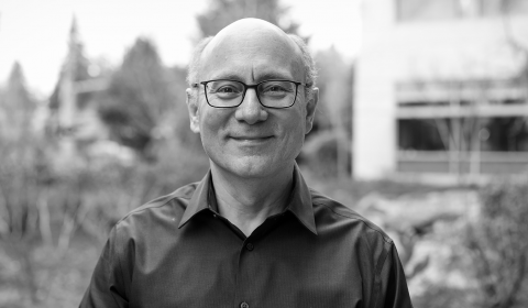 Rico Malvar, Chief Scientist and Distinguished Engineer standing in front of bushes