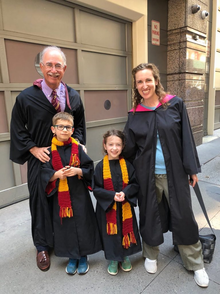 a grandfather, mother, and two children—and they are dressed in Harry Potter costumes.