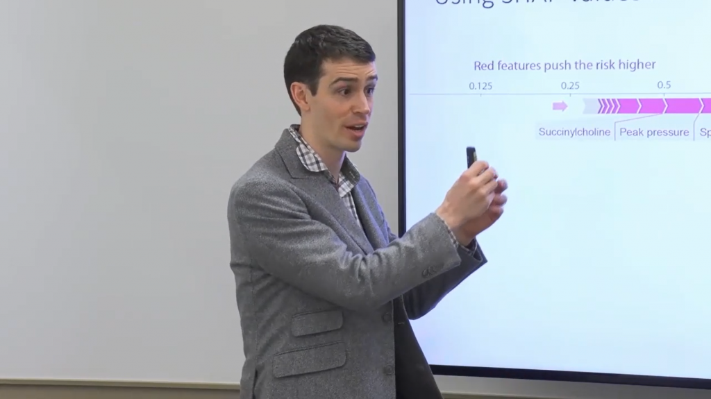 a man standing in front of a screen
