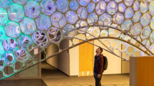 Jonathan Lester stands underneath the art project 