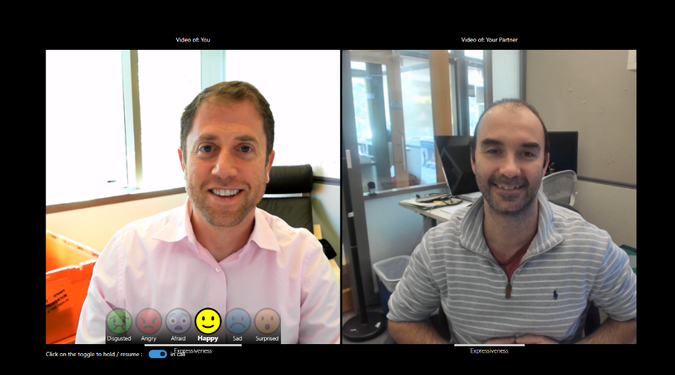 a man sitting in front of a computer screen