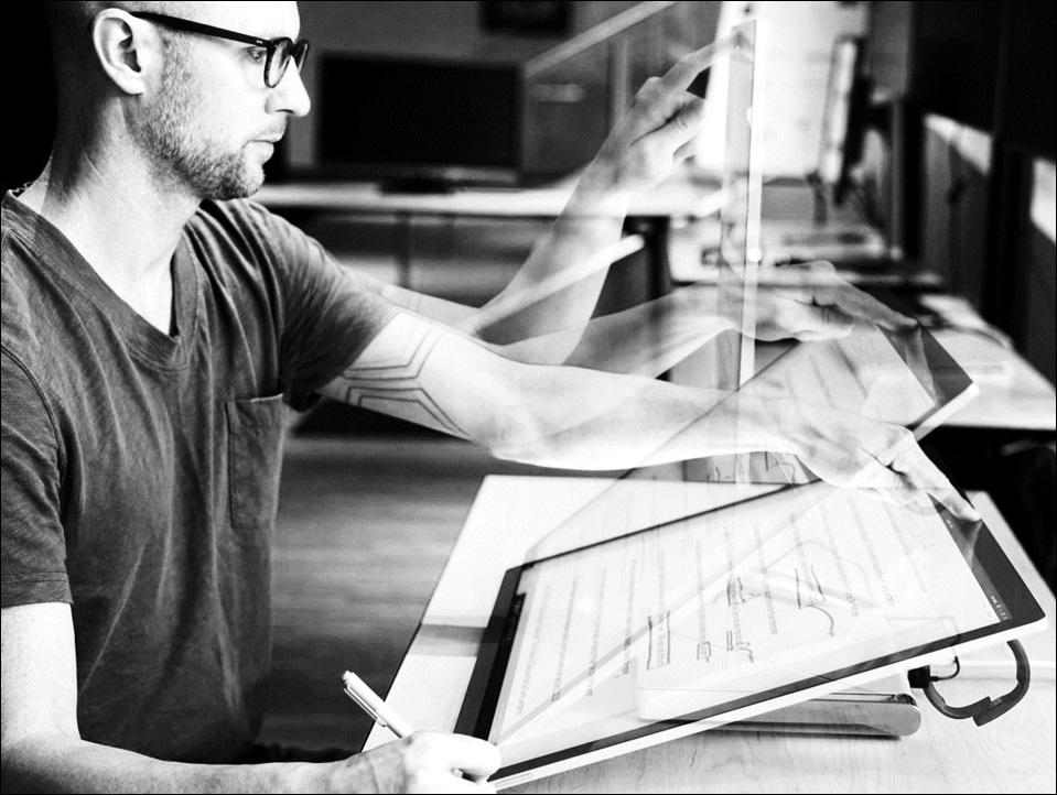 User adjusting the tilt angle of a display from vertical to a low-angled drafting table