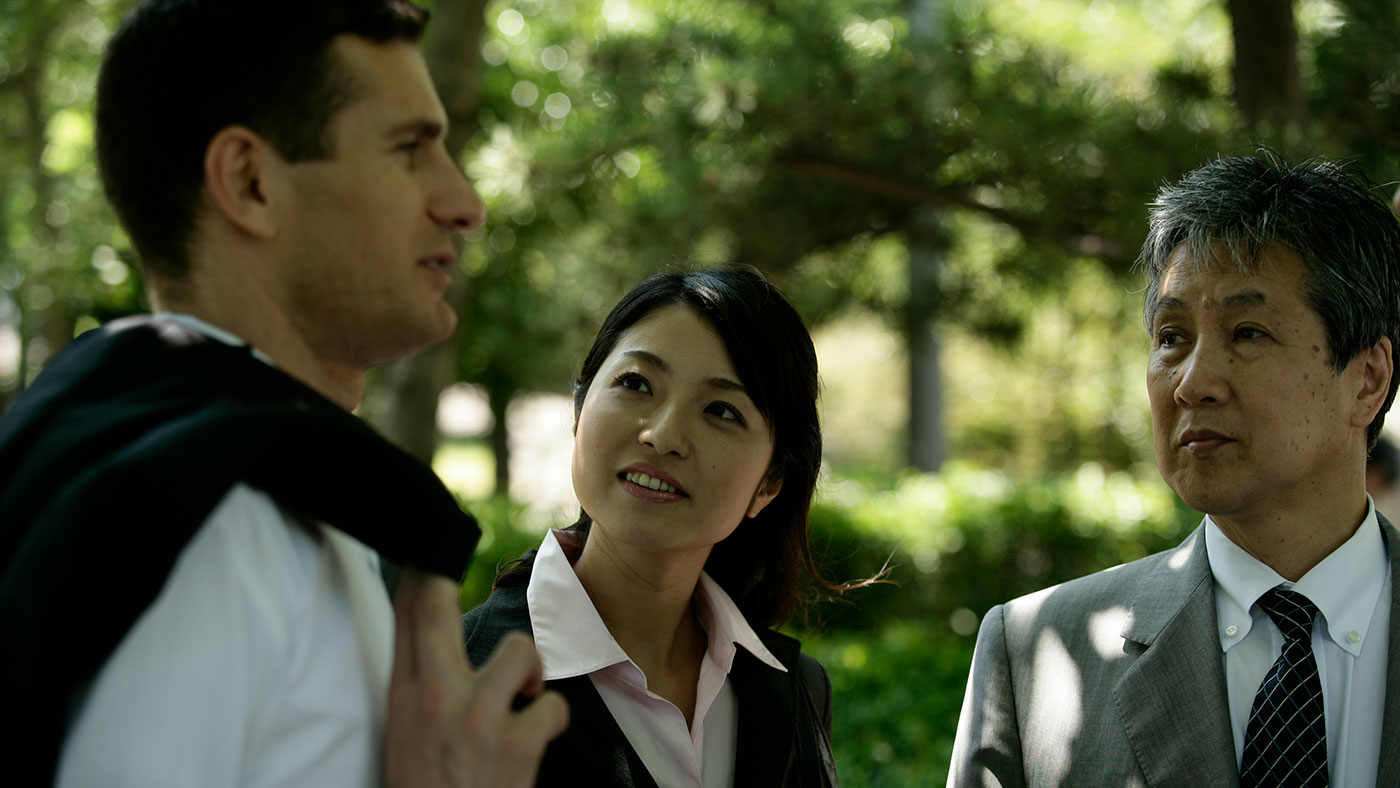 photo of three business people talking in an outdoor setting