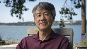 Peter Lee standing in front of a body of water