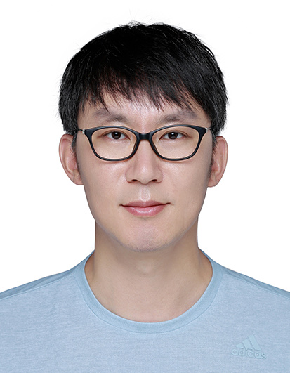 a man wearing glasses and looking at the camera