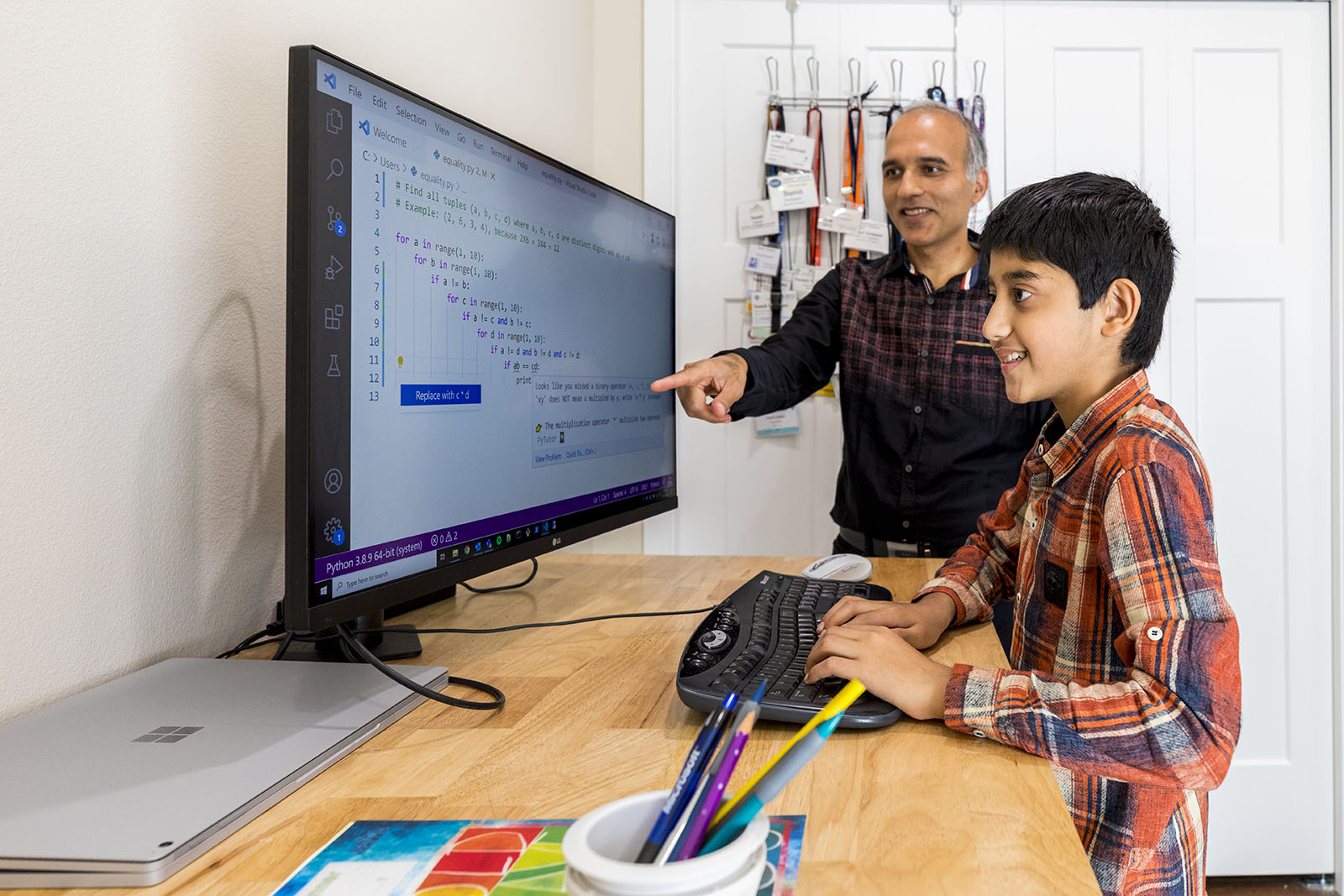 Sumit Gulwani standing in front of a computer