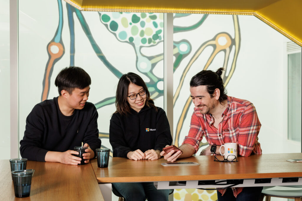 Three residents collaborating sat at a table