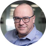 Christopher Bishop wearing glasses and looking at the camera