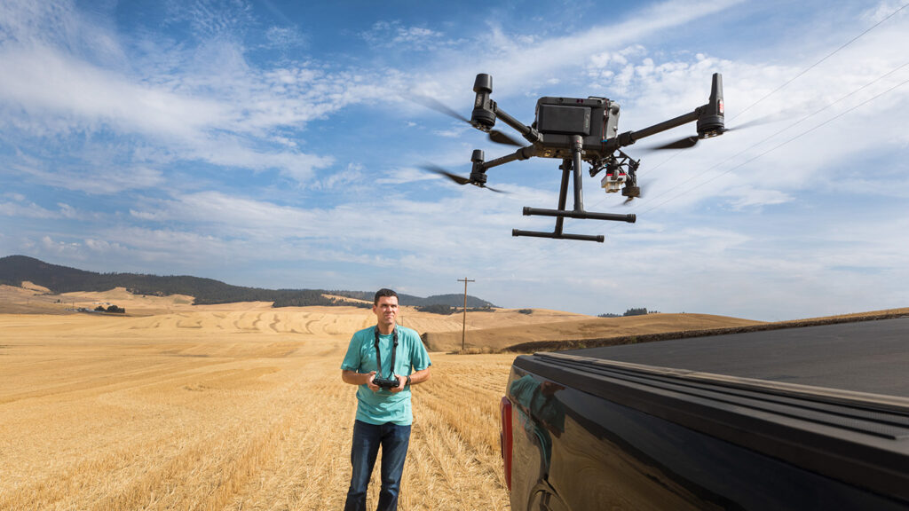 Andrew Nelson launches a drone from the back of a pickup truck