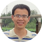 Qi Dai wearing glasses and smiling at the camera