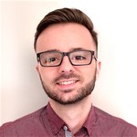 Shane Storks wearing glasses posing for the camera