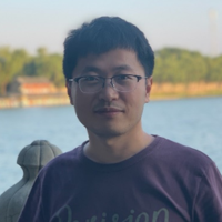 a man standing in front of a body of water