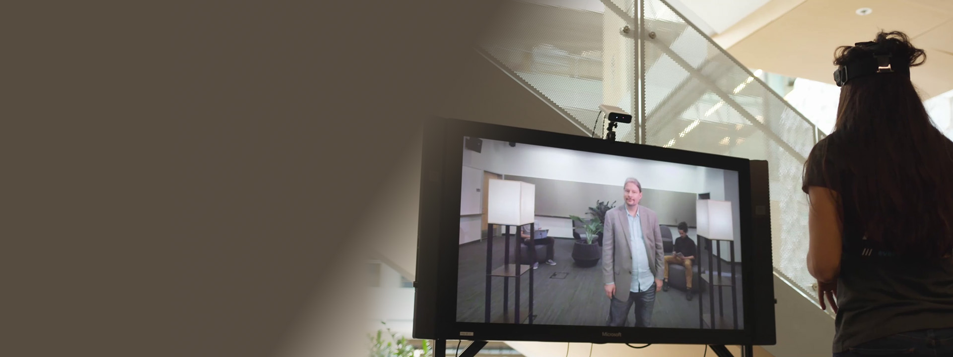 woman facing a video screen using a Living Display for a video coference
