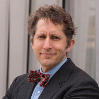 James Evans wearing a suit and tie