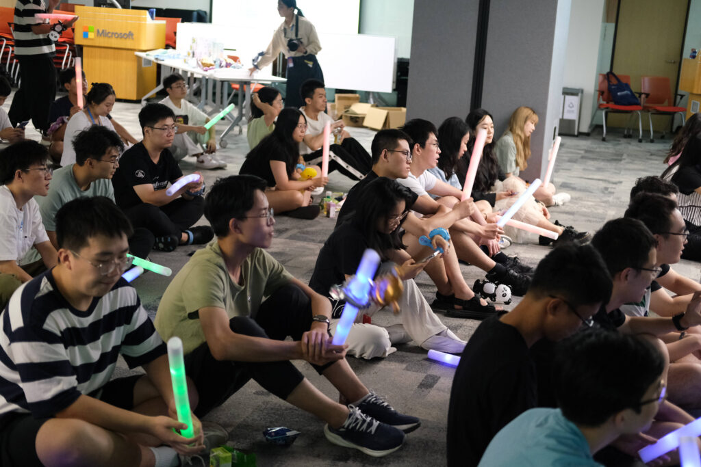 a group of people sitting in front of a crowd