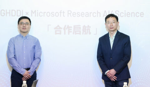 a person standing in front of Sheng Ding et al. posing for the camera