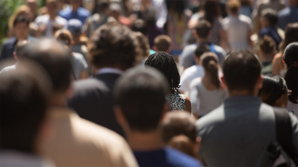 Crowd of people walking through the streets