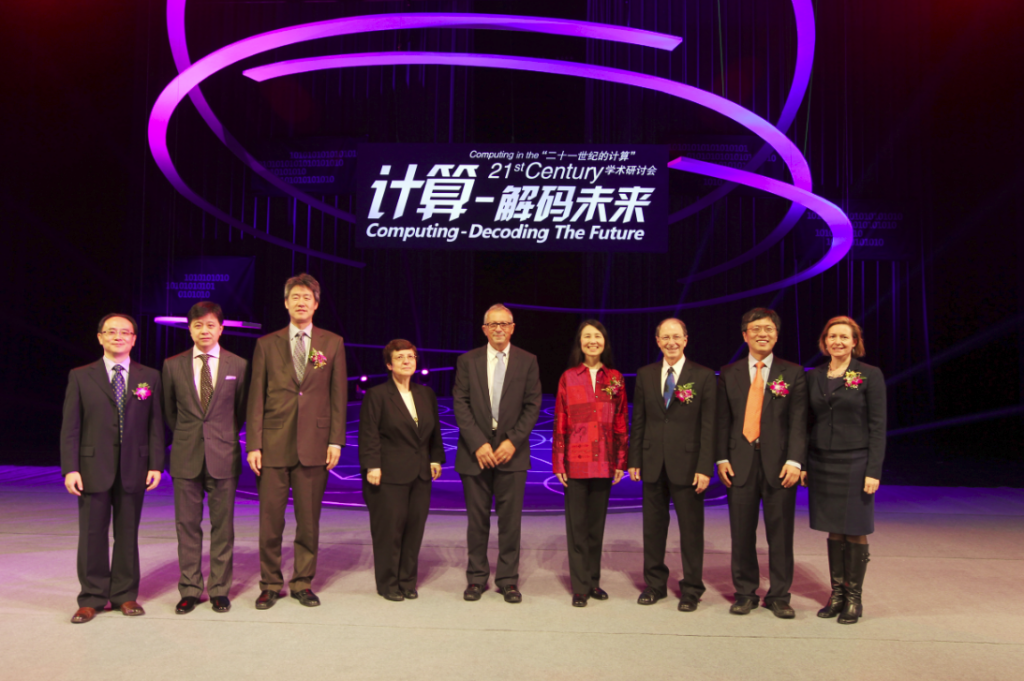 a group of people standing on a stage posing for the camera
