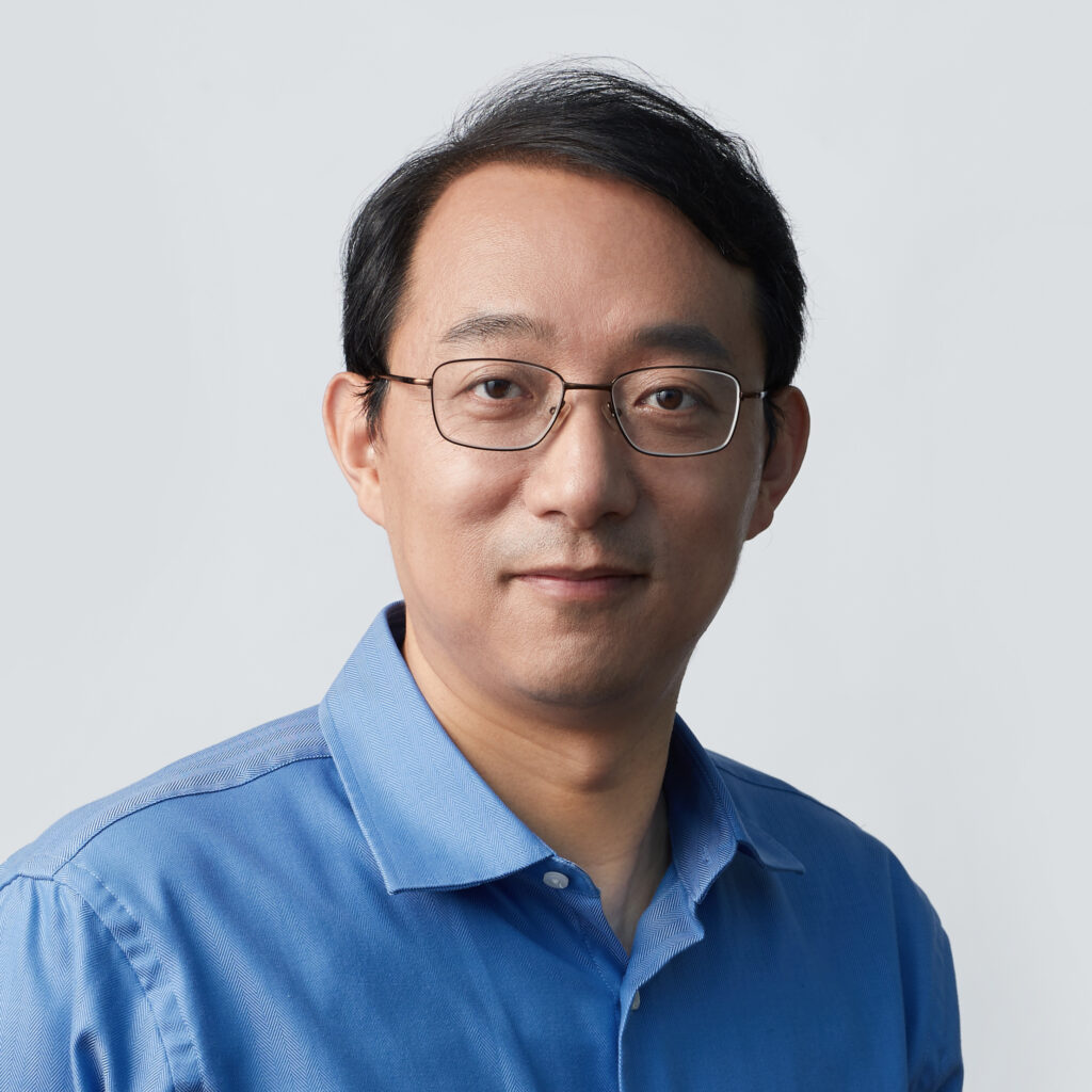 a man wearing glasses and a blue shirt
