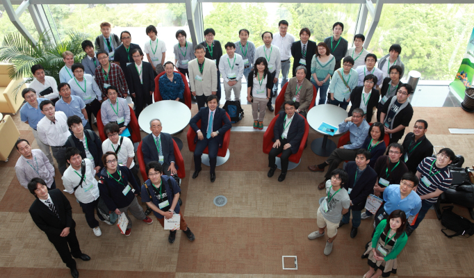 a group of people standing in front of a crowd posing for the camera