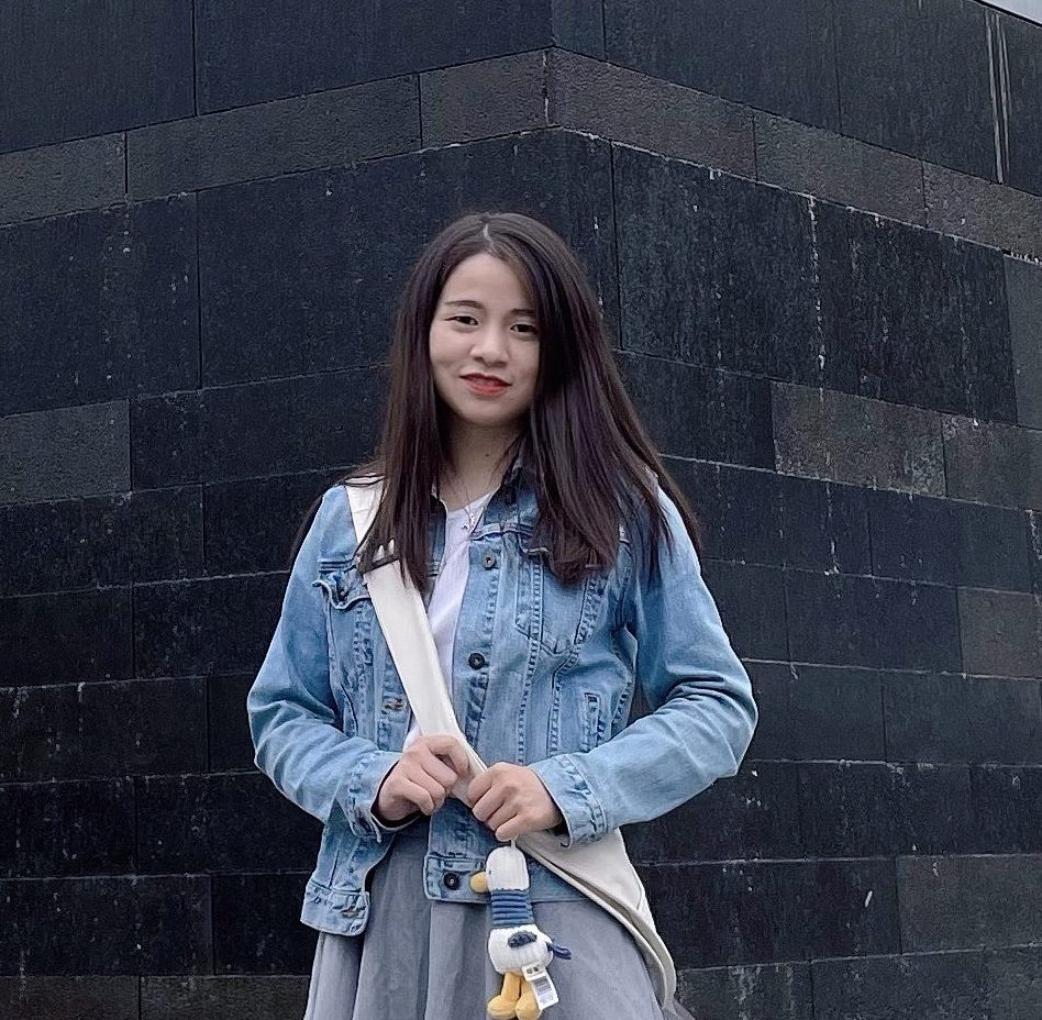 a person standing in front of a brick building