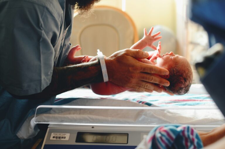 close up of a nurse holding a newborn infant