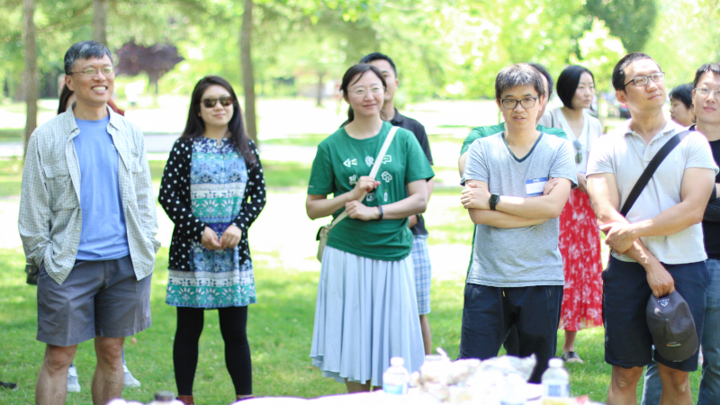 Harry Shum et al. that are standing in the grass
